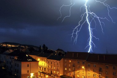 Lightning strikes above downtown Savannah townhomes at night