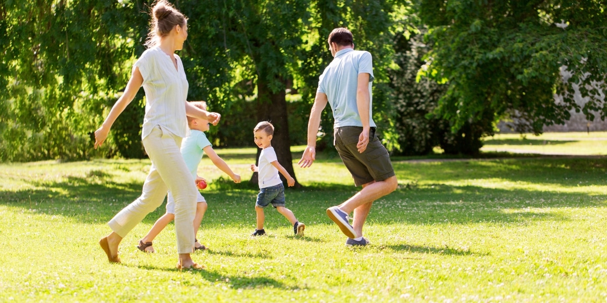 A family playing in a greenspace 
