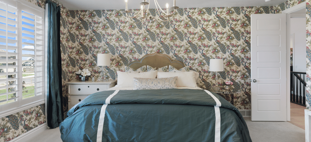 A bedroom with fresh wallpaper, staged for a home sale.