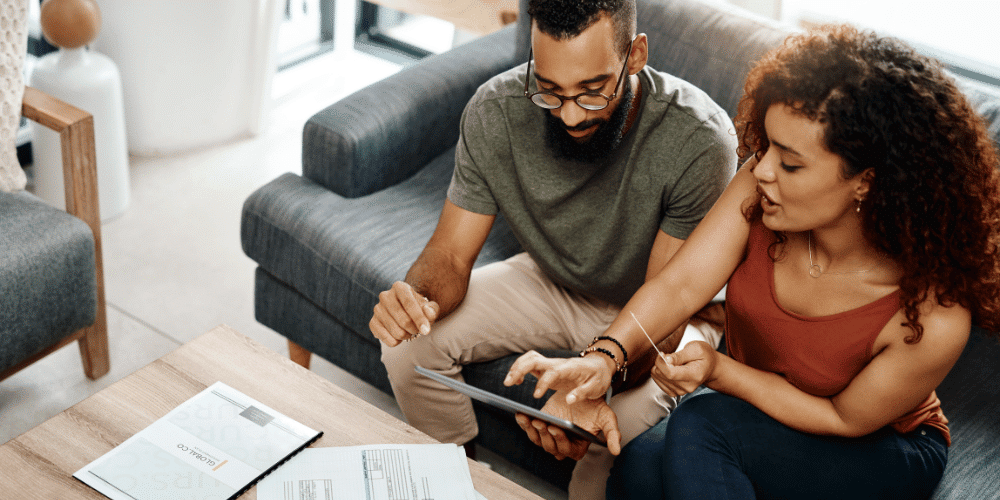 A couple determining their budget for purchasing a vacation rental property