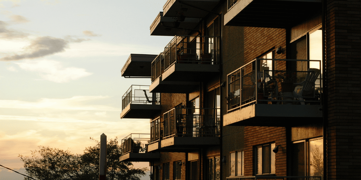 The exterior of a condo building at dusk