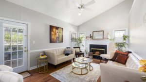 A modern, open-concept living room and kitchen with elegant finishes, showcasing the spacious floorplans available at Del Webb Savannah at Heartwood.