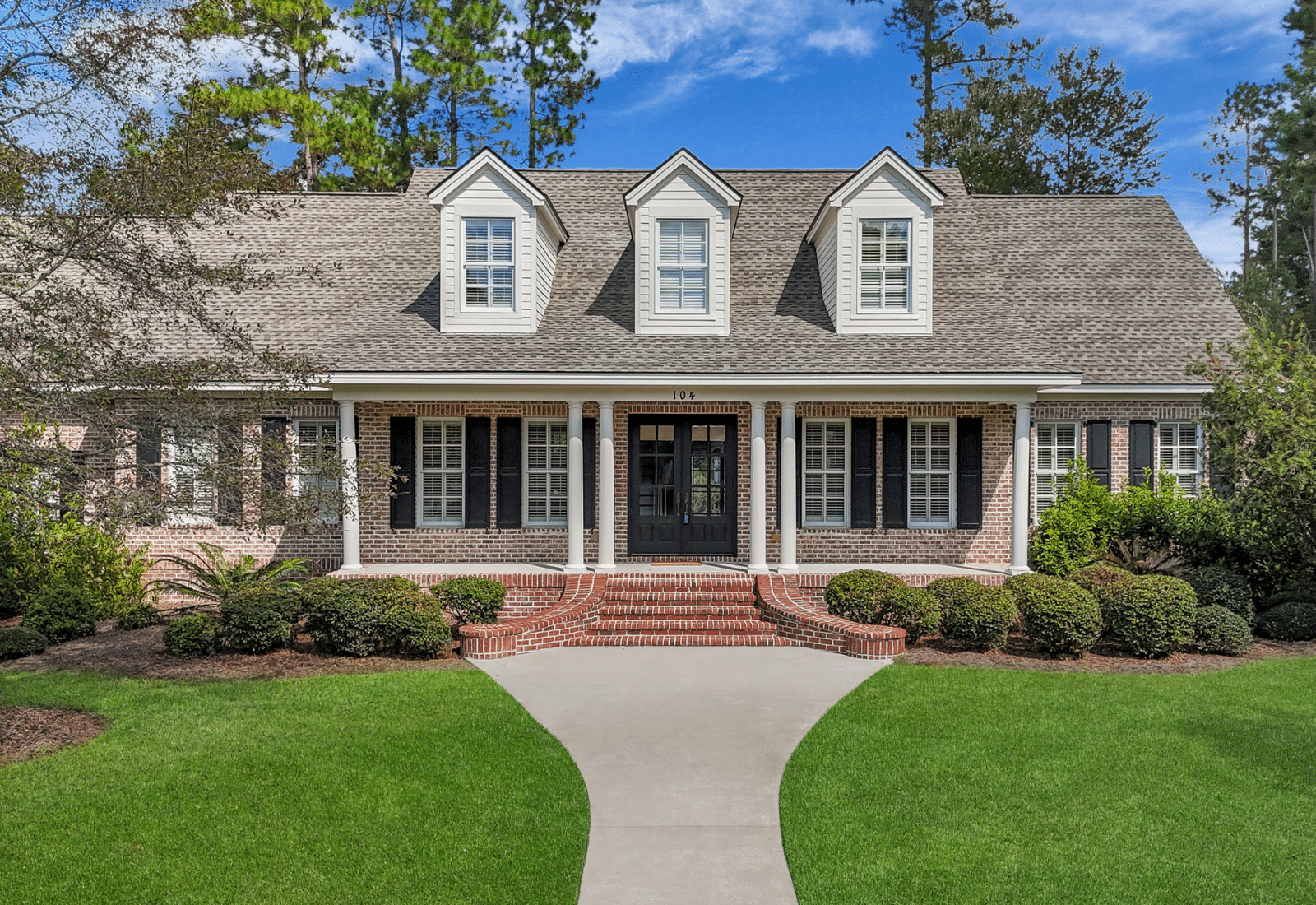 Custom built luxury estate home in Westbrook at Savannah Quarters with manicured landscaping